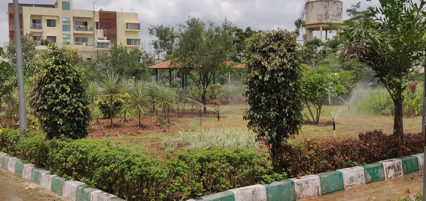 A park in Bangalore's residential area being watered by sprinklers