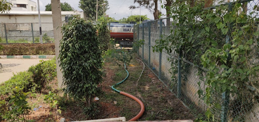 A Bengaluru park being irrigated from a water tanker