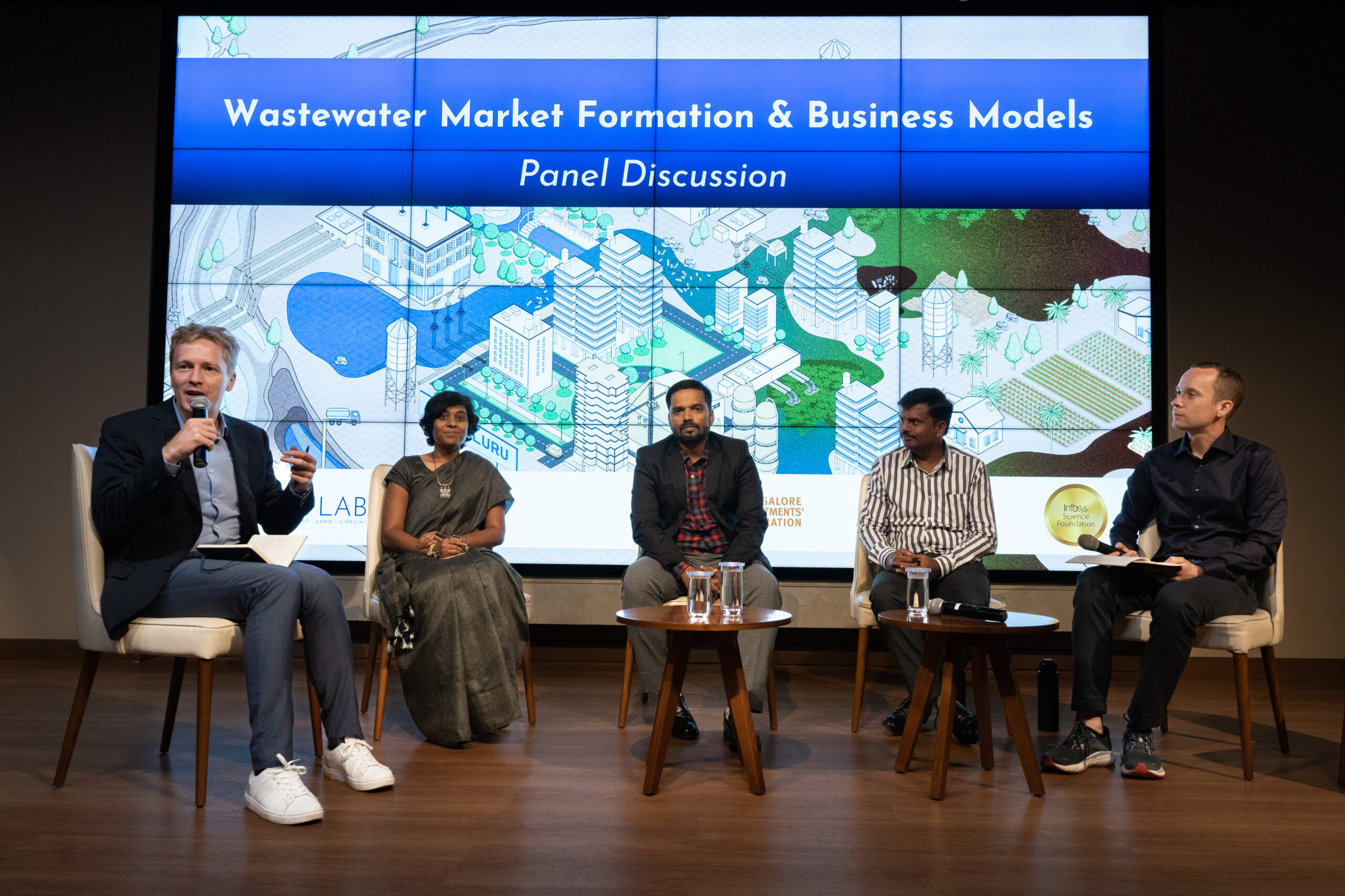 Panellists - Mr Gowthaman Desingh, Ms Moulya Donthi, Mr Vijay Kumar N - discuss wastewater markets and business models in a discussion moderated by EAWAG's Dr Christian Binz and Dr Johan Miörner.