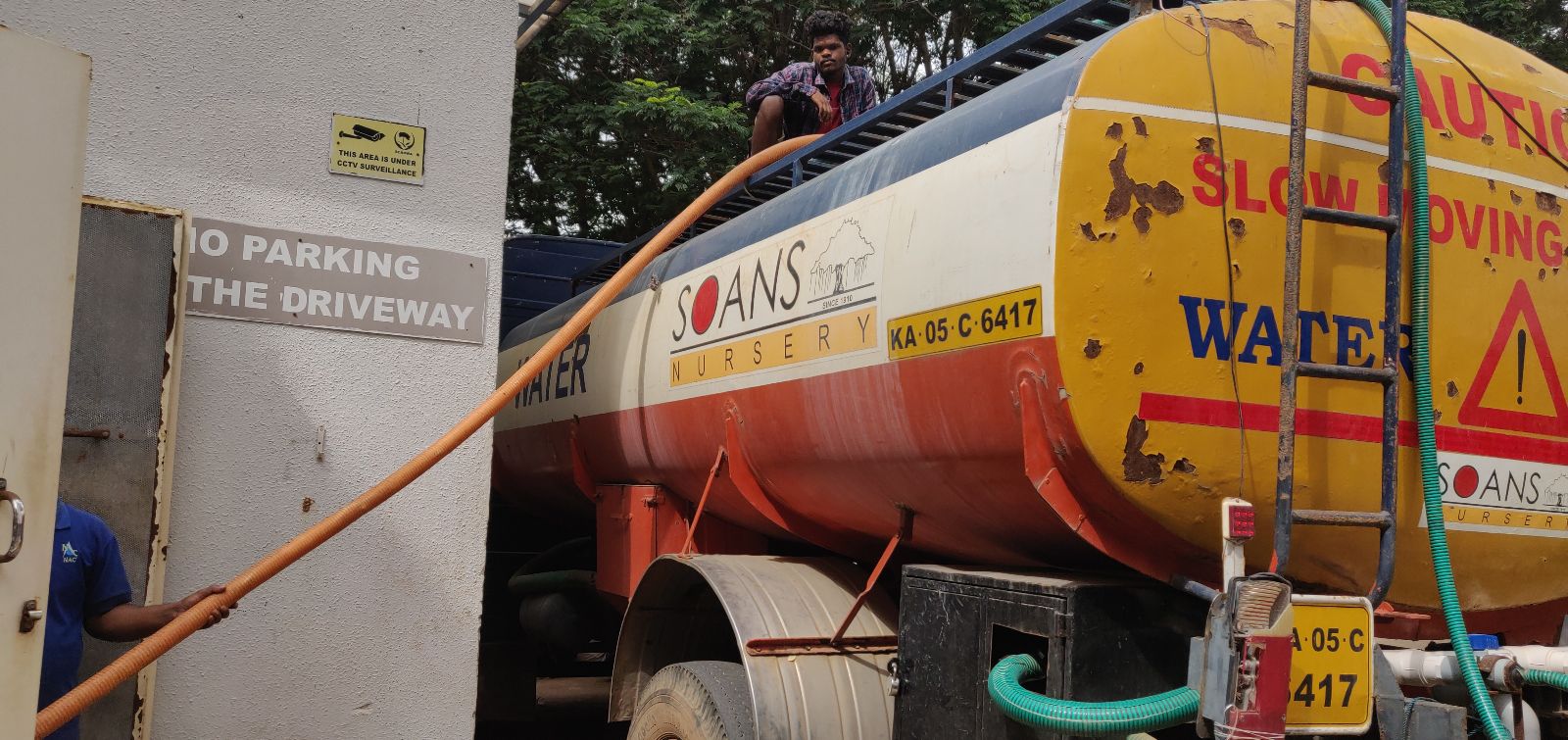 A water tanker being filled in Bengaluru, Karnataka, India.