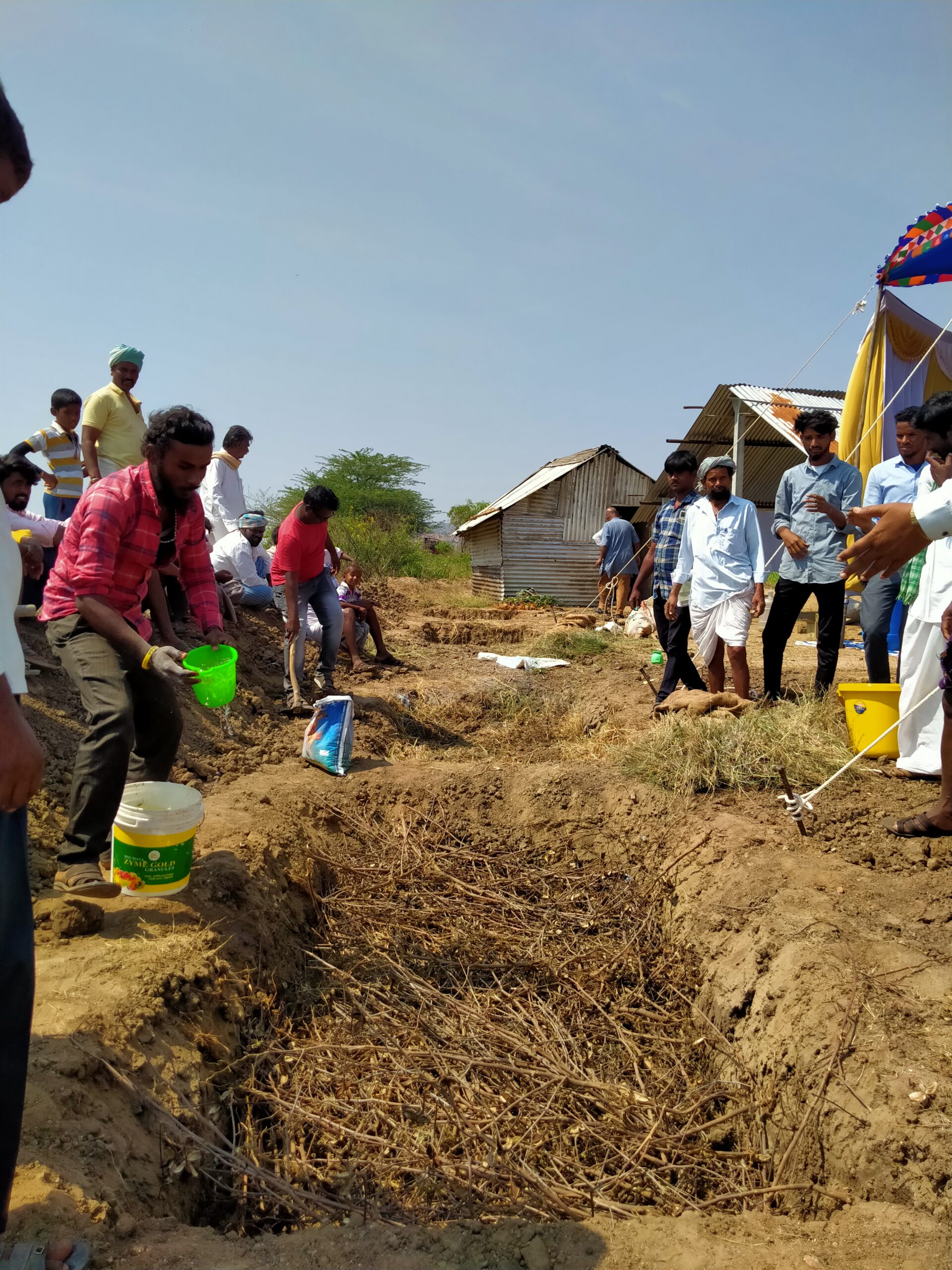 At a workshop organised by Soil Vasu, farmers learn to make compost from crop residue inside a trench-cum-bund pit.