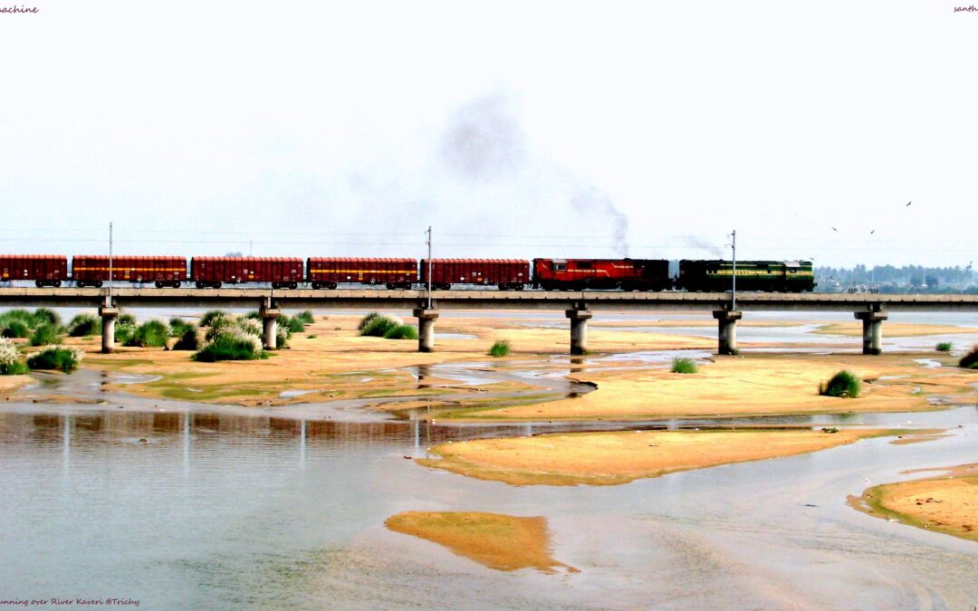 A goods train moves on a bridge on the Kaveri river delta near Trichy in Tamil Nadu, India.