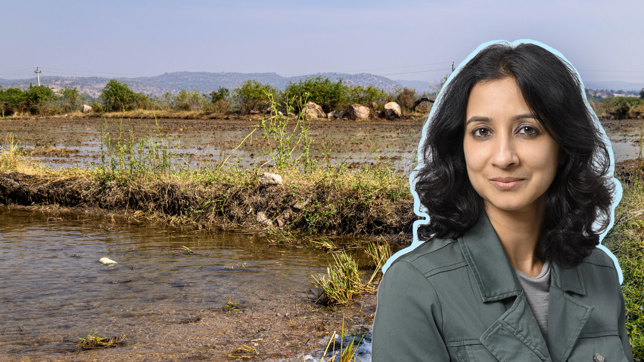 Soumya Balasubramanya in the foreground, with a farm flooded with water in the background.