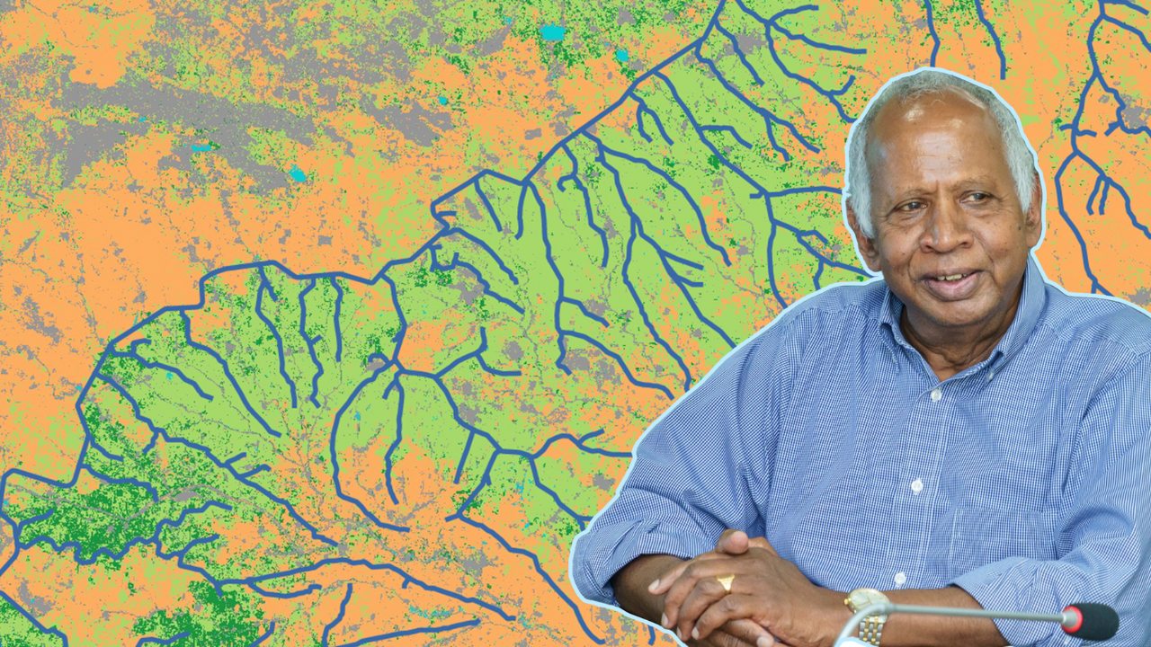 A man wearing a blue striped button up shirt and white hair in the foreground, with an illustration of a river system in the background. The river is marked in blue, while land is marked in yellow and green.