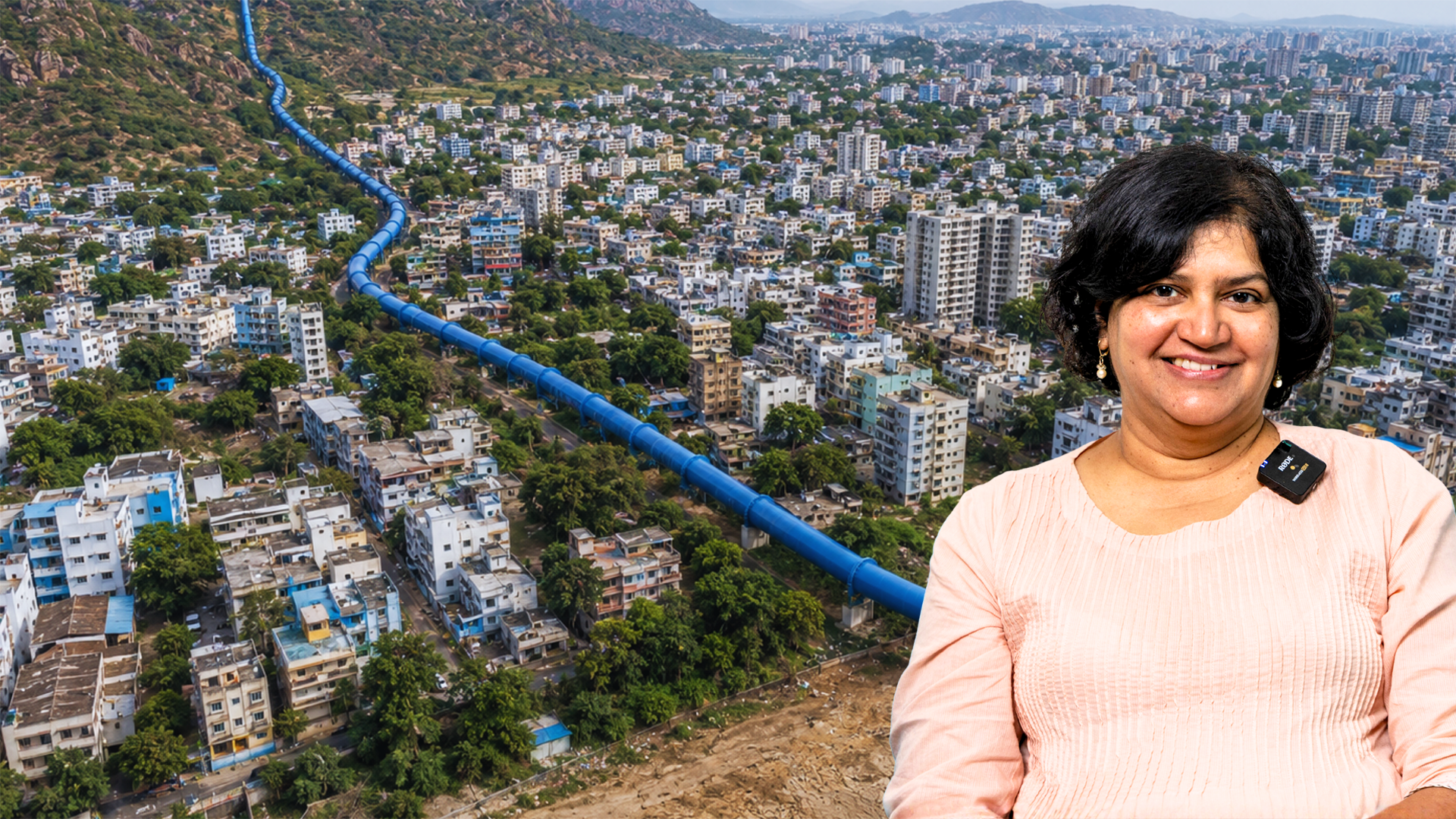 Image of a woman in the foreground, with the image of a large water pipe in an urban area with large apartments and dense housing.